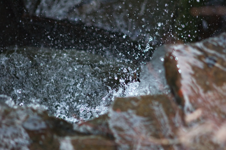 Water drops frozen as they fall over a small waterfall