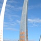 Three curved metal shafts point skyward