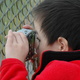 Michael composes a shot through the fence