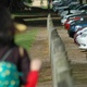 A line of cars and fence-posts