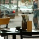 A view into the street, past an empty table