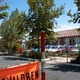 Streetscape with an orange school crossing sign in the foreground