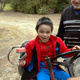 Michael sits proudly on a ride-on mower