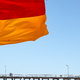 A flag in the foreground of a jetty