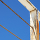 A white handrail against a blue sky