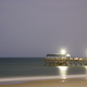 Jetty, beach, and sky at night