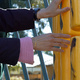 Hands reaching out to a big noughts and crosses board