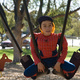 Michael sits on two swings at once