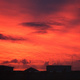 Deep red sunset over city skyline