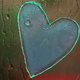 Rain drops and a heart-shaped sticky thing on a window