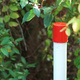 A red and white fire plug marker