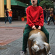Michael sitting on a bronze pig sculpture in Rundle Mall