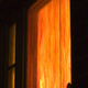 A glowing, orange-painted window at night