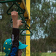 Michael hanging from playground equipment