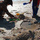 Michael and Theen playing with sand, at the beach