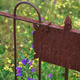 A rusty wrought-iron grave