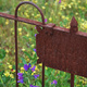 A rusty wrought-iron grave