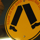 A yellow pedestrian sign