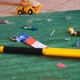 A child walking past toys that are scattered on the floor