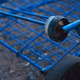 A blue cart, abandoned by the side of the road