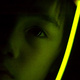 Michael holding a glow-stick next to his face