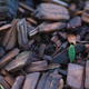 A leaf fragment, on a bed of bark chips