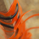 Orange safety netting tied to a post with black nylon ties